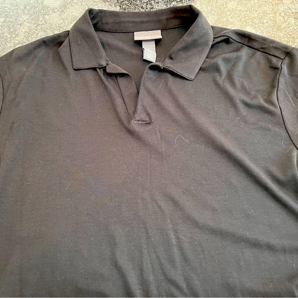 H&M black polo shirt with open collar. Never worn. Size L